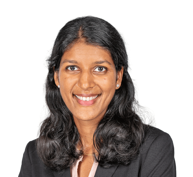 Smiling professional with long dark hair, wearing a dark blazer, against a white background.